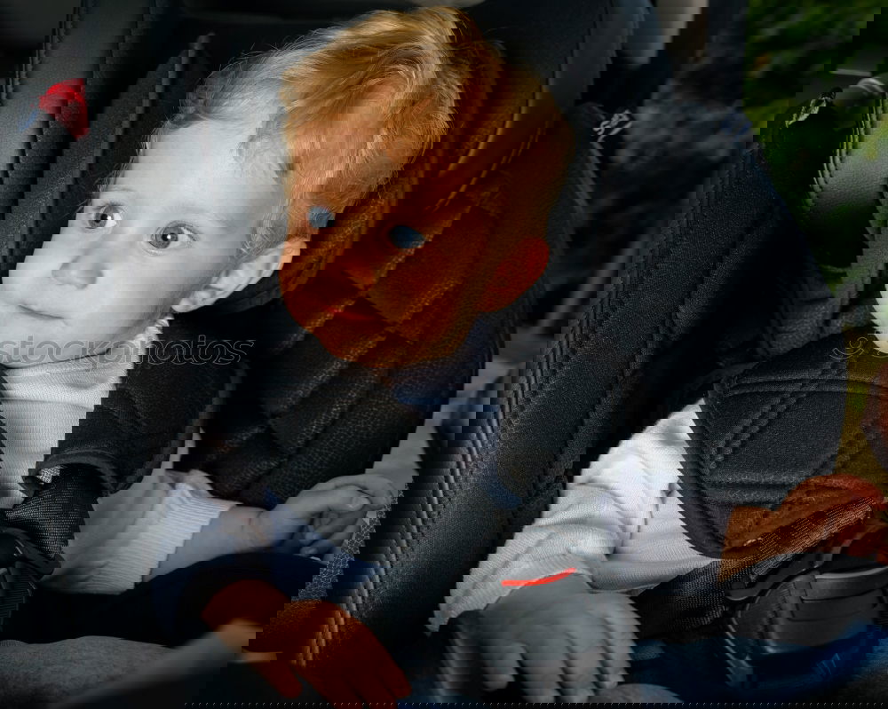 Similar – Image, Stock Photo One little boy sitting in the car and look out from the car window at the day time. Concept of happy trip.