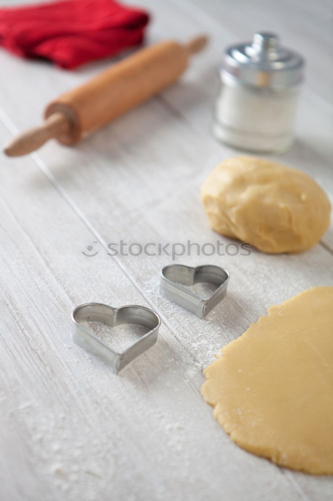 Similar – Image, Stock Photo Close up of cookie cutters and rolling pin on a dark table