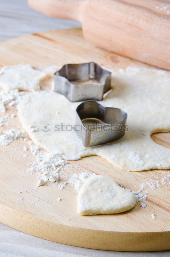 Similar – Image, Stock Photo Close up of cookie cutters and rolling pin on a dark table