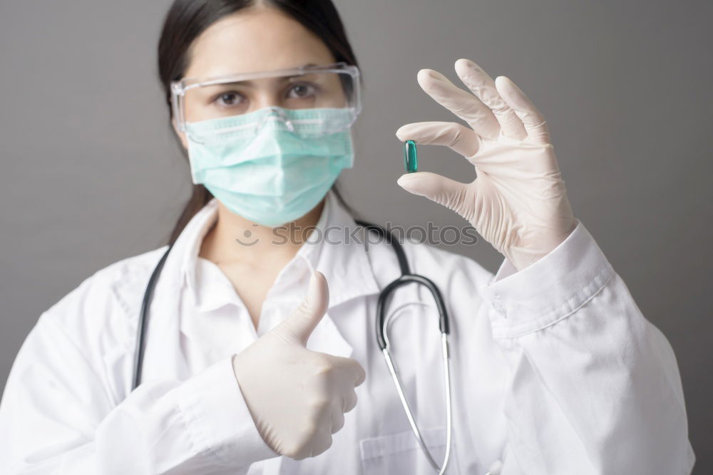 Similar – Image, Stock Photo Female doctor with face mask, protective gloves and lab coat