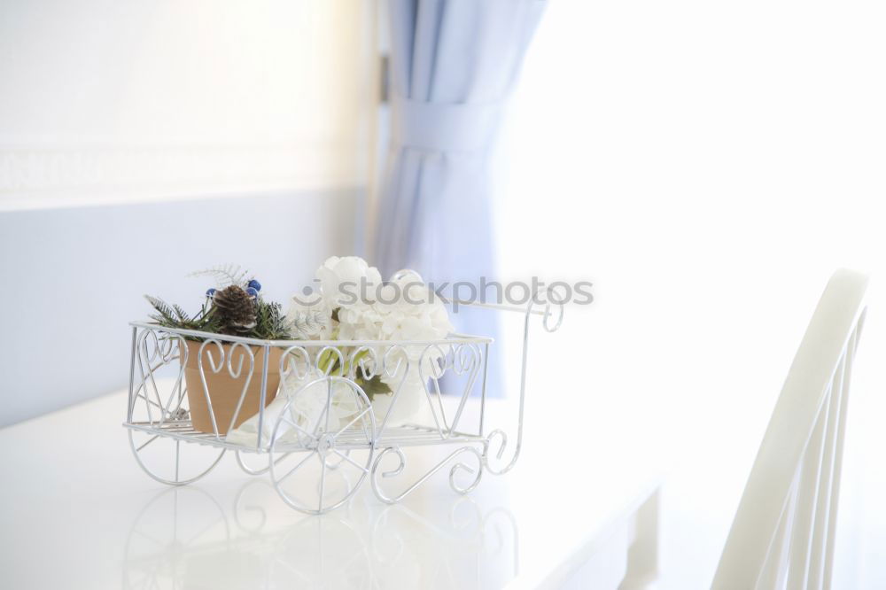 Low angle view of a pretty wedding bouquet of white flowers lying on a table top with selective focus and copyspace