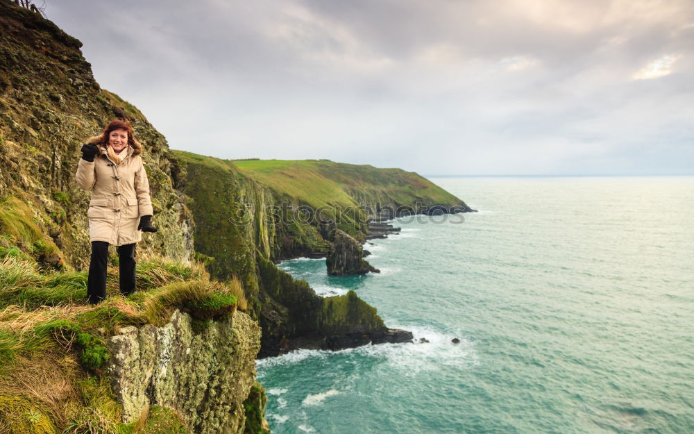 Similar – Image, Stock Photo Woman standing on the coast by the sea in England