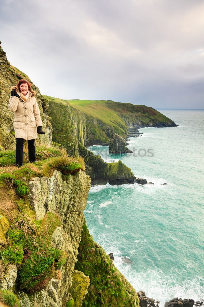 Similar – Image, Stock Photo Woman standing on the coast by the sea in England