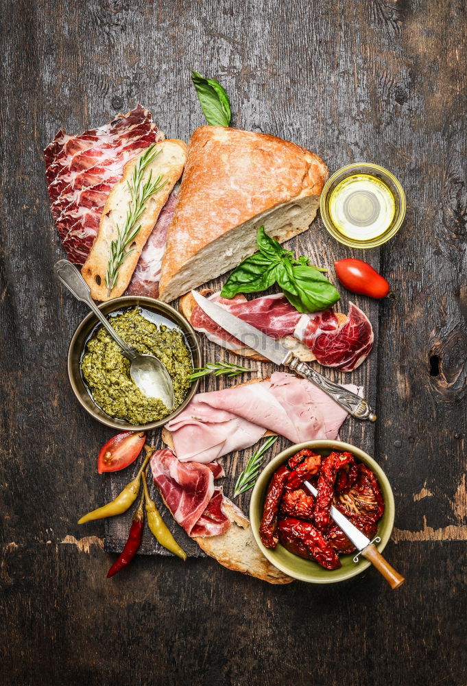 Italian meat platter with antipasti and ciabatta bread