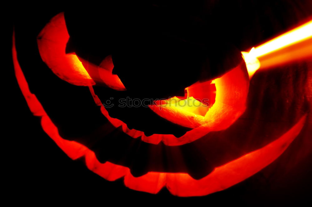 Similar – Creepy carved Halloween pumpkin burns in fire flames