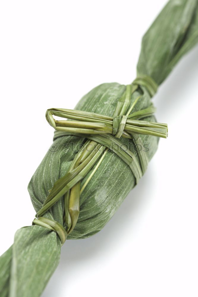 Similar – A portion of green asparagus, freshly harvested from the local field, decorated with a plaid ribbon of cloth, tied together, lies in the light on the table, on a white cloth of linen.