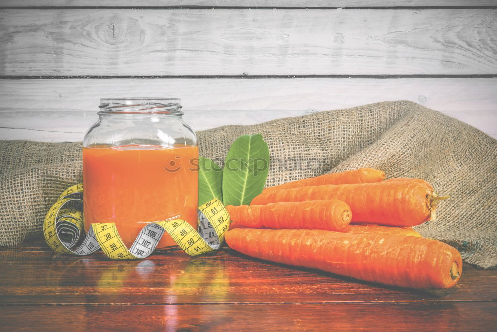 Carrot juice in glass jars and iron mug