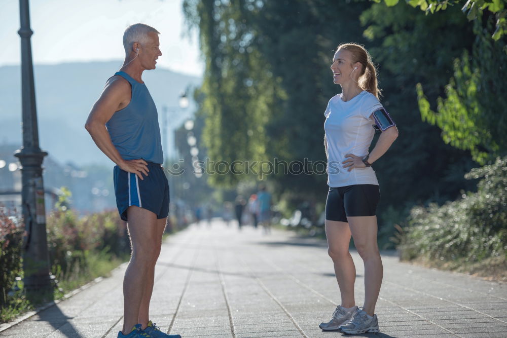 Similar – Active young couple jogging side by side in an urban street