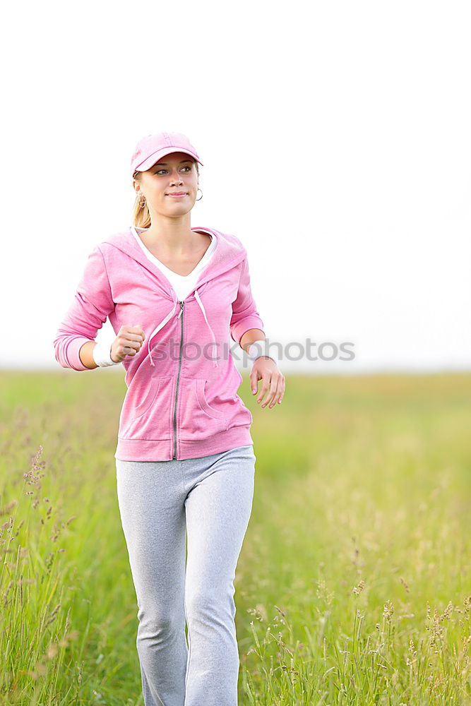 Similar – Cheerful woman running through field