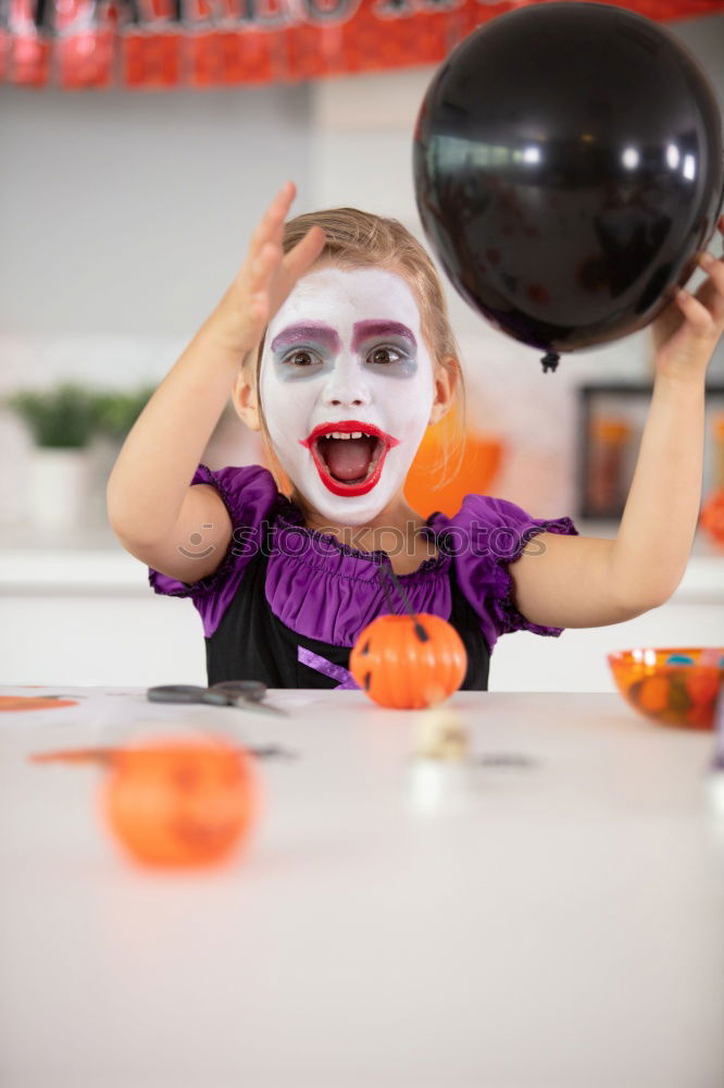 Similar – Girl with dirty hands showing tongue in room