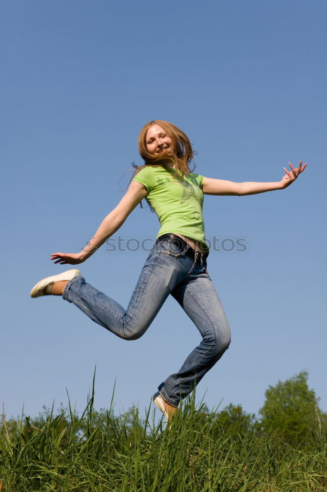 Similar – young woman jumps for joy with outstretched arms towards the sky