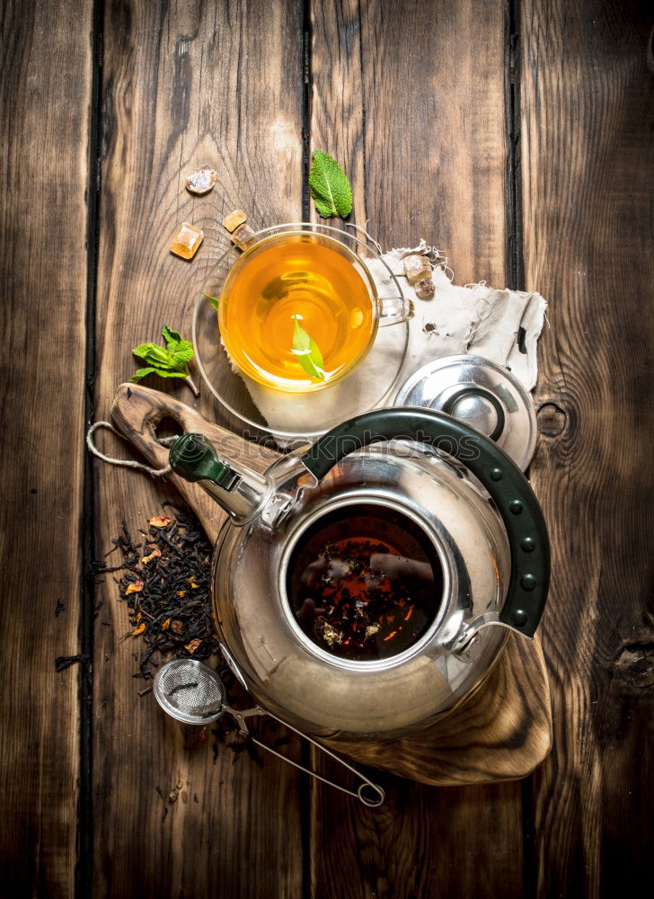 Similar – Black tea with jasmine in a white cup on a brown wooden table