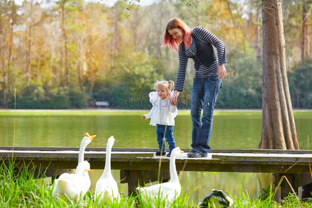 Similar – Image, Stock Photo Young boy and his little sister sitting on jetty over the lake and dipping feet in water on sunny day in the summertime