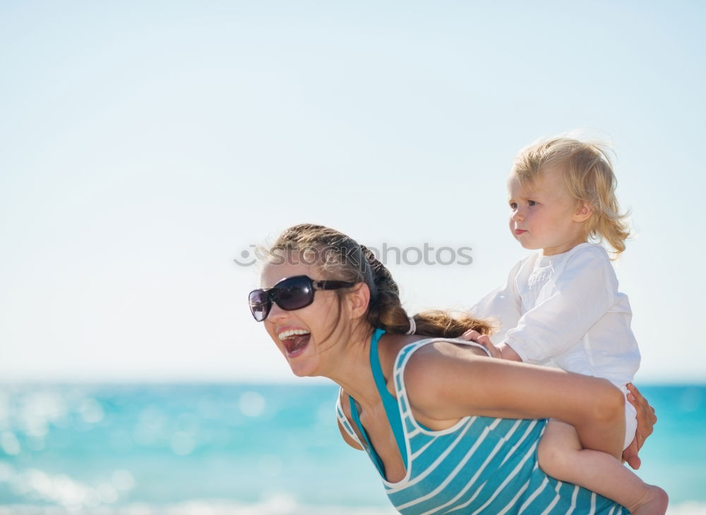 Similar – Mother and children playing on the beach at the day time. Concept of friendly family.