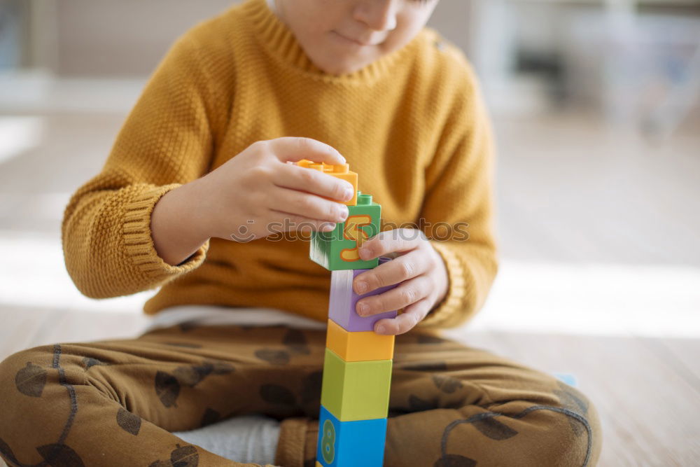 Toddler boy playing with new toy wearing pyjamas