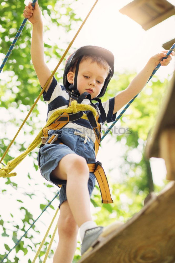 Similar – Cute black boy having fun on a swing in his parents garden