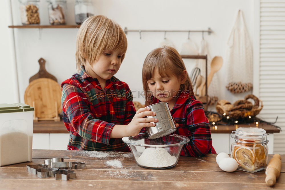 Similar – Little sisters girl preparing baking cookies.