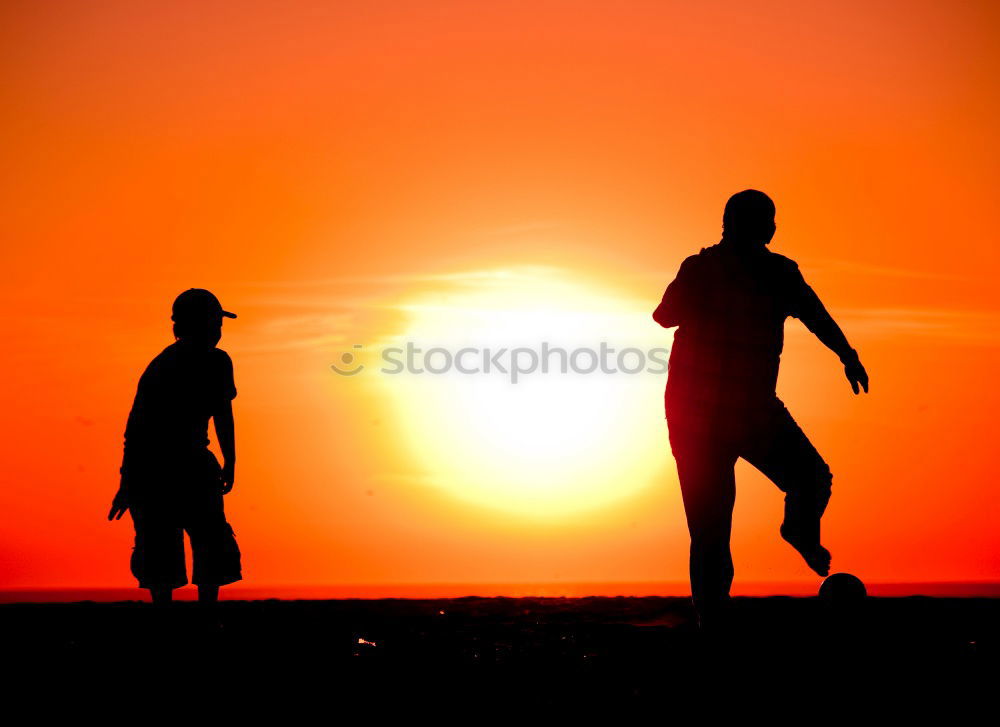 Similar – Father and son playing on the beach at the sunset time.