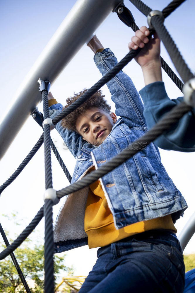 Woman with afro hair climbing by children’s attractions.