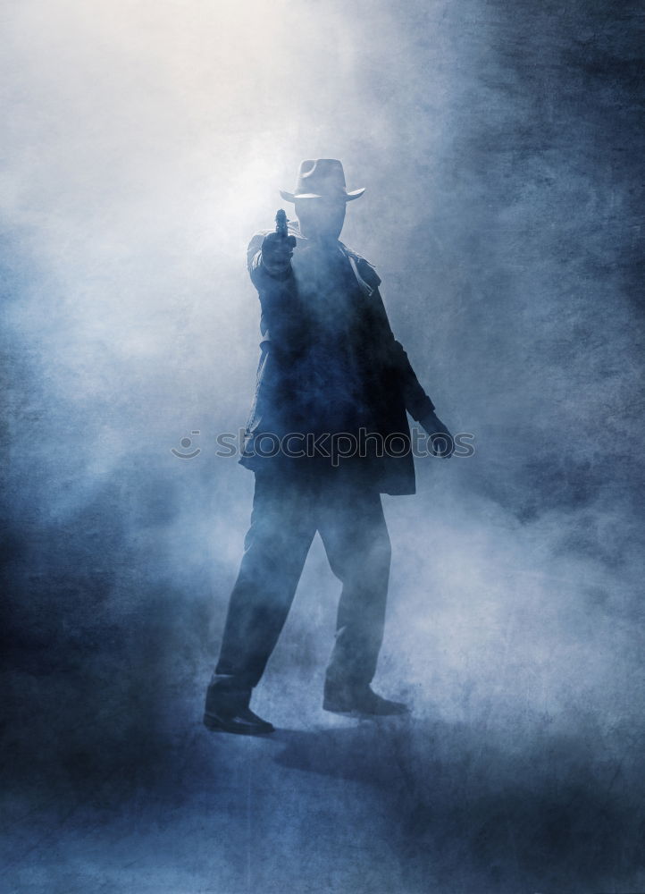 Woman wearing trench coat and standing in fog