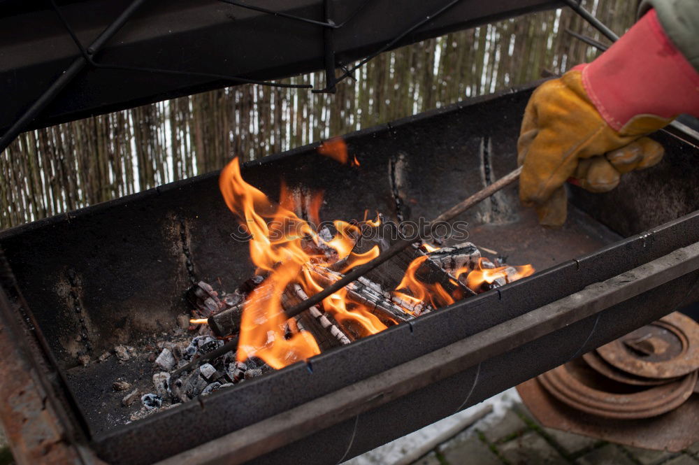 Similar – Ein großer Kochtopf hängt über offenem Feuer einer Feuerschale.