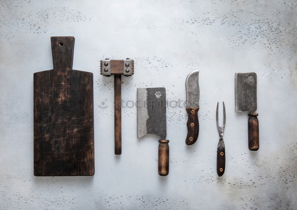 Similar – wooden cutting board and knife with sharpening on the table