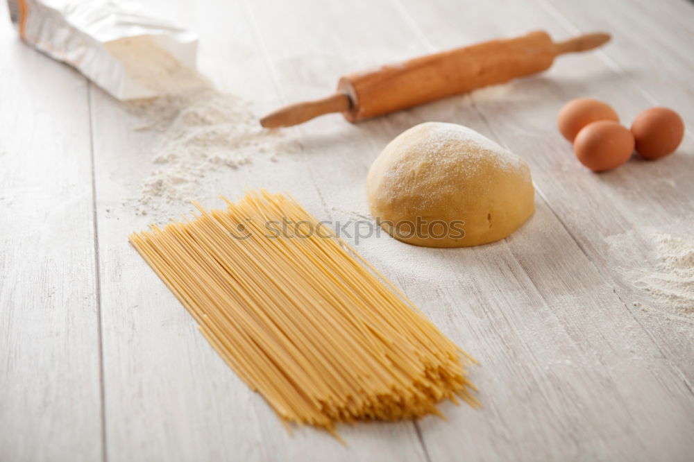 Similar – Image, Stock Photo Making homemade taglatelle with a pasta rolling cutter