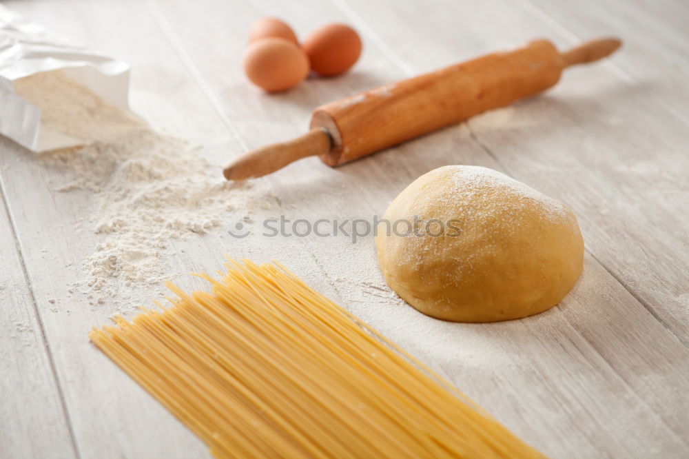 Similar – Image, Stock Photo Making homemade taglatelle with a pasta rolling cutter