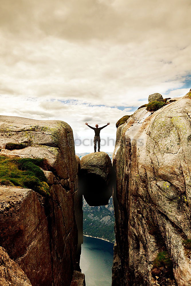 Tourist jumping over gorge