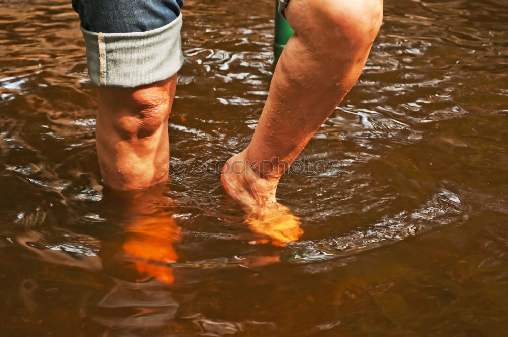 Similar – Image, Stock Photo Legs in leather boots in puddle