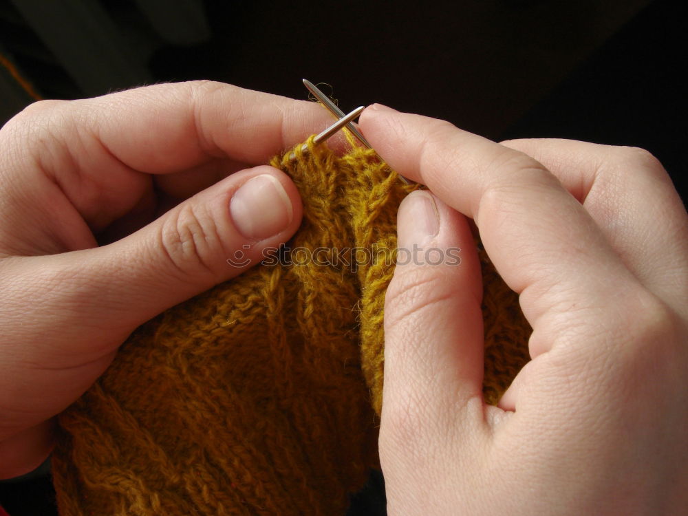 Similar – Close up of the hands of an elderly woman knitting sock