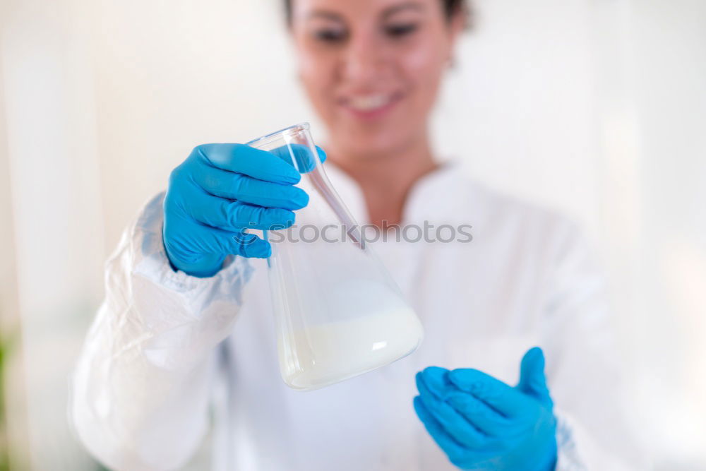 Similar – Image, Stock Photo Woman holding flask in lab