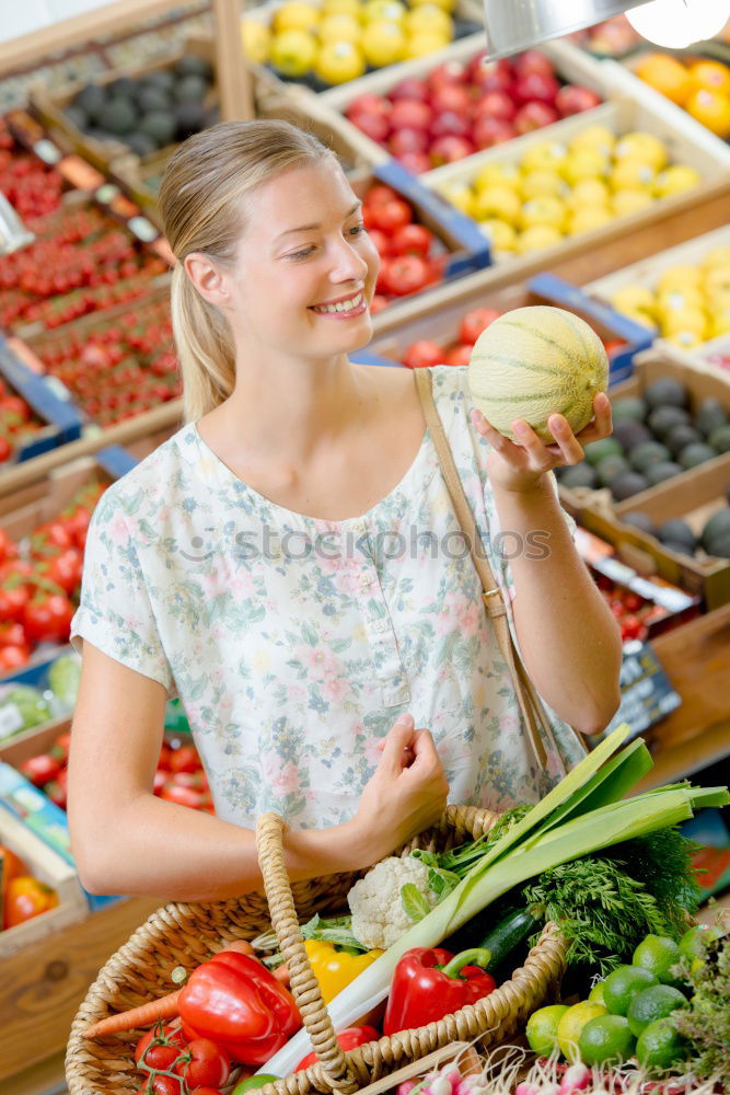 Similar – Image, Stock Photo Young woman shopping for fresh tomatoes at an open-air stall choosing items from a row of wooden boxes