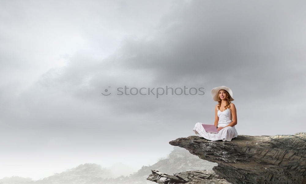 Similar – Man relaxing on cliff