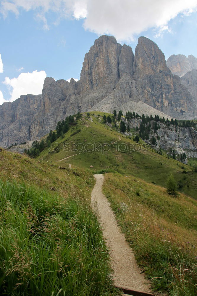 Hiking trail with hiker with panoramic view in the Dolomites