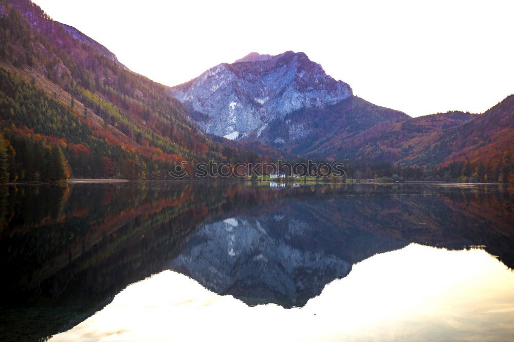 Similar – Wonderful lake between hills in snow and cloudy sky