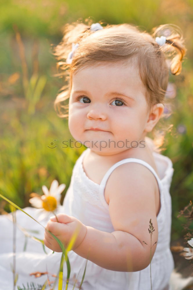 Similar – Little girl walking in nature field wearing beautiful dress