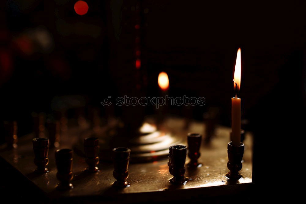 Similar – Image, Stock Photo Theme day: diverse/candlelight, candle offering in a church. Many candles are placed on a staircase. With dark background.