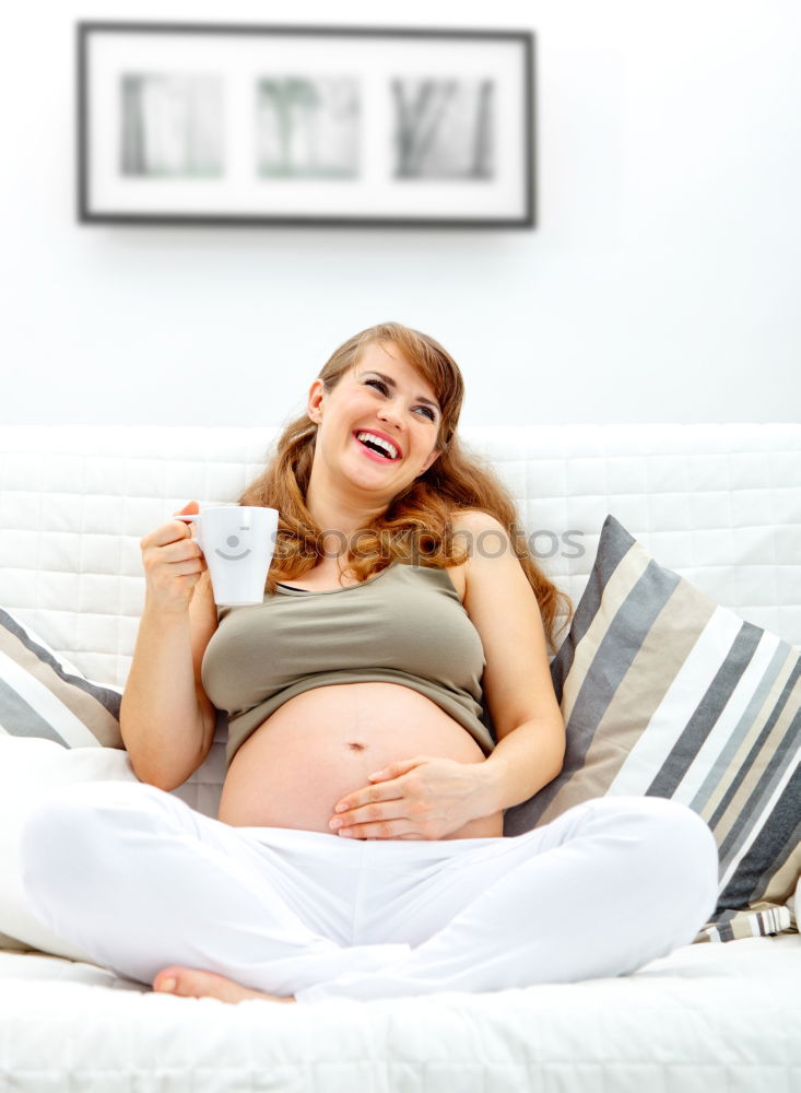 Similar – Pregnant woman touching her belly