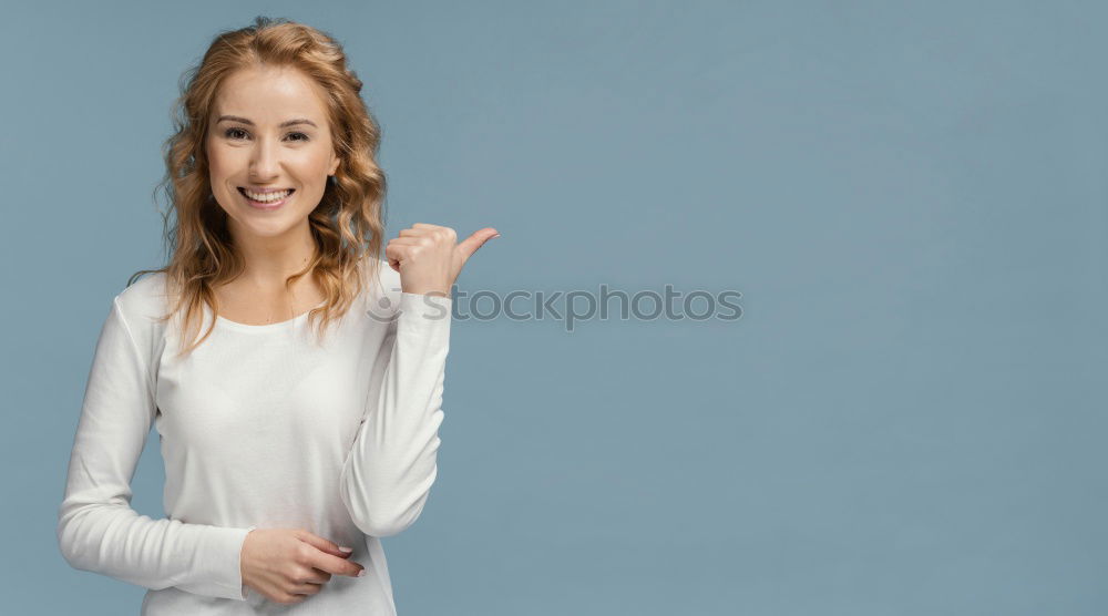 Similar – Young blonde woman smiling near a brick wall