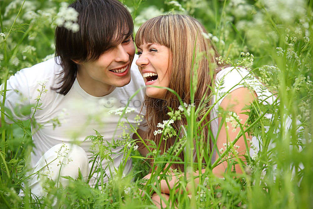 Similar – Happy smiling couple laying on green grass