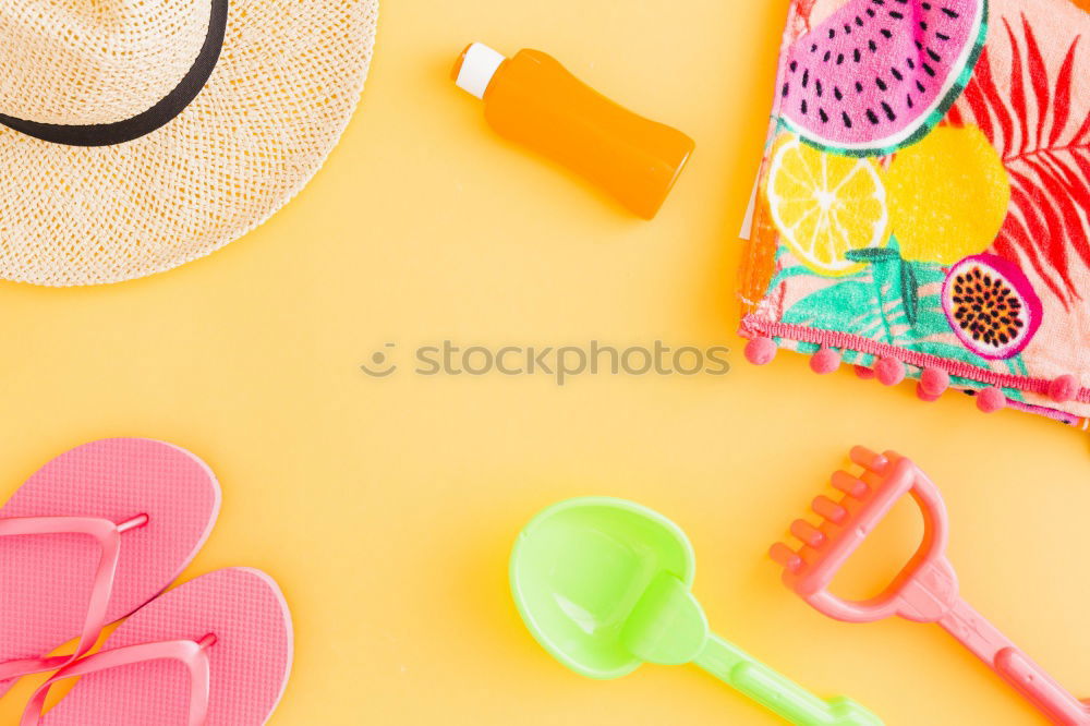 Straw hat with sunglasses and tropical leaves