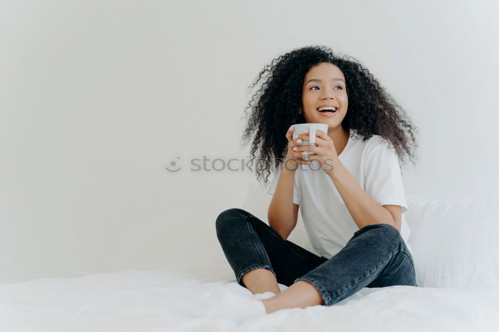 Similar – close up of a pretty black woman with curly hair smiling and lying on bed looking away