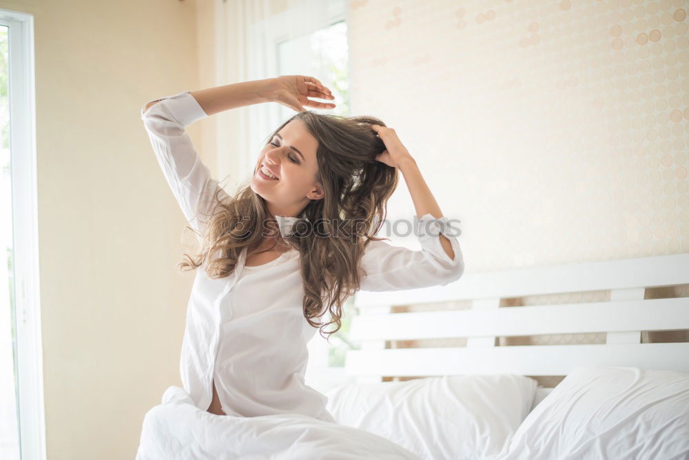 Similar – young slim redhead woman with curls sits barefoot in hot pants on parquet floor and looks at camera