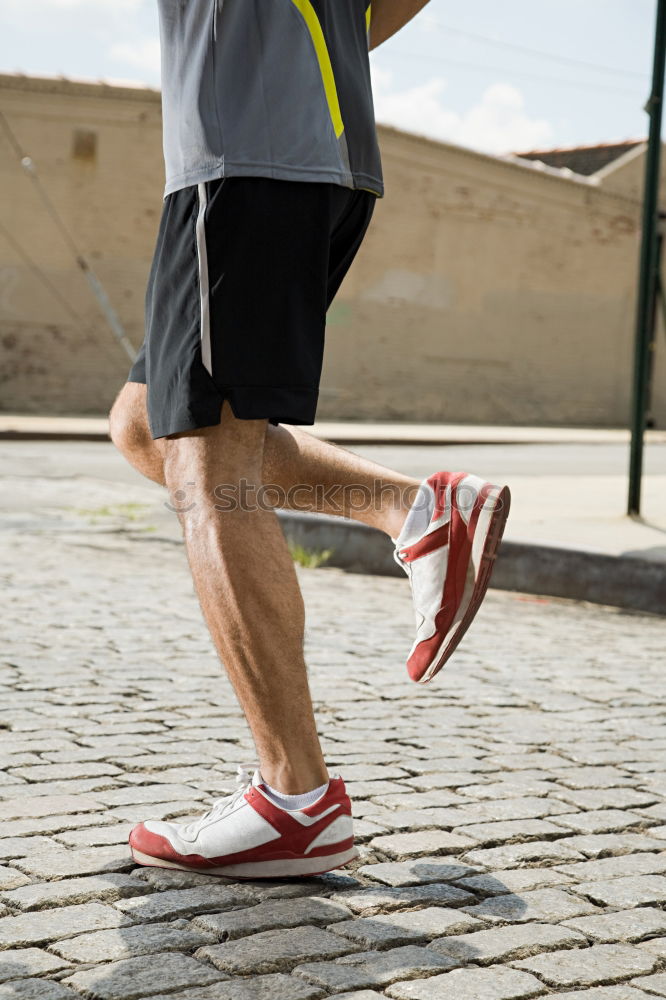 Similar – Image, Stock Photo Close-up shot of man tying running shoes with foot on the bench. Getting ready before jogging. Going in for sports, healthy lifestyle