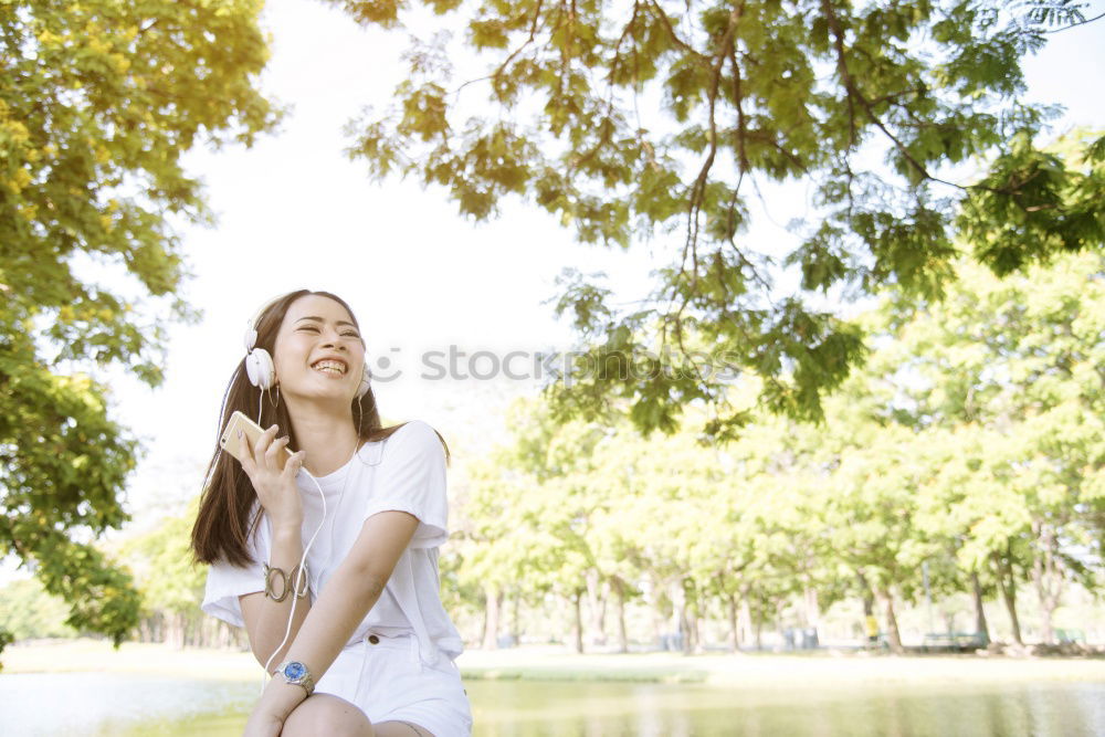 Similar – Brunette woman leaning on handrail at river