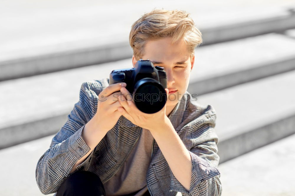 Similar – Young modern man sitting on halfpipe taking picture with Camera