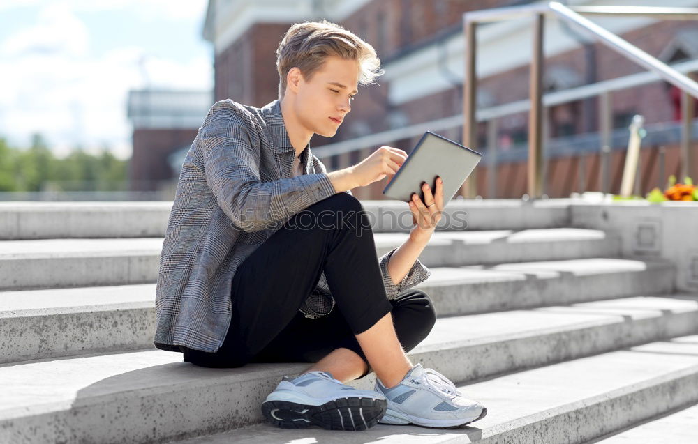 Image, Stock Photo young boy looking at tablet pc computer with frustrated look on his face