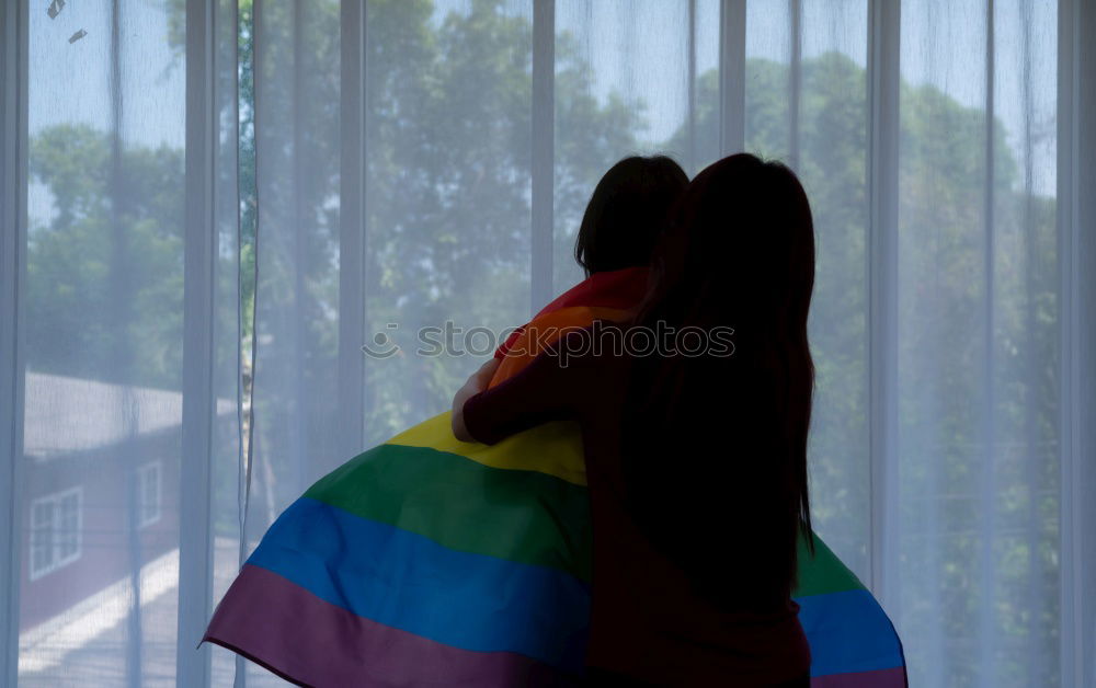 Similar – Image, Stock Photo Young woman holding a rainbow flag behind a fence