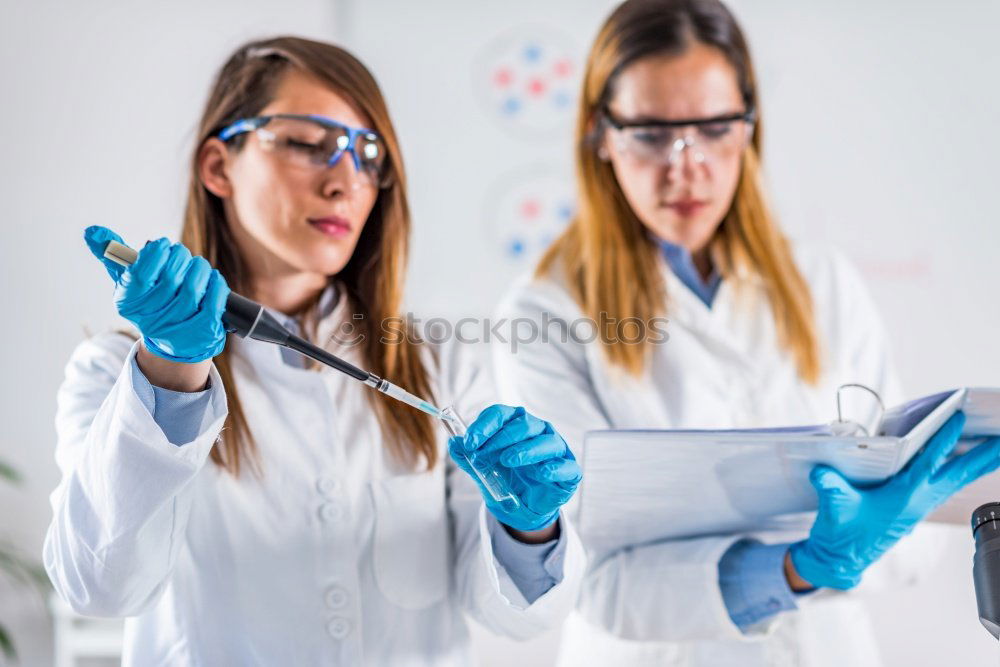 Similar – Image, Stock Photo Woman holding flask in lab